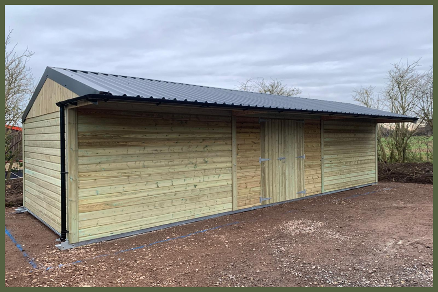 High-quality timber garden storage shed with solid wooden cladding, secure double doors, and a weatherproof roof, ideal for outdoor equipment and tools.